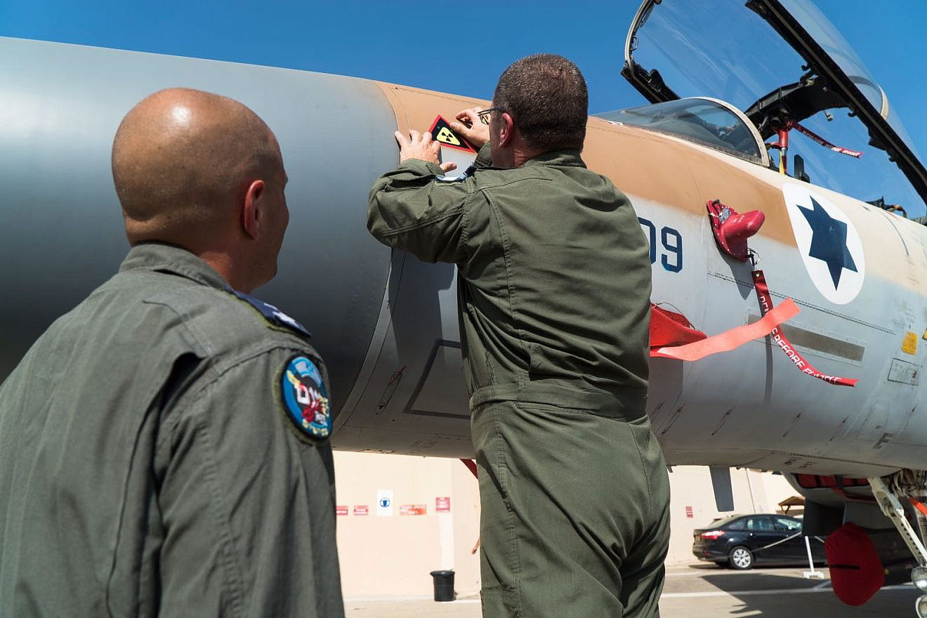 A member of “Operation Outside the Box” marks a plane that took part in the bombing of Syria's Deir a-Zour nuclear reactor in September 2007. Source: IDF Spokesperson's Unit.