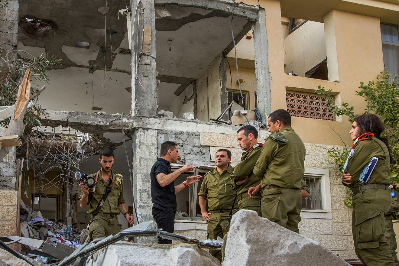 Maj.-Gen. Herzi Halevy (center), the chief of the Israeli Southern Command, visits the scene where a building was hit by a rocket fired by Hamas in Gaza in the southern Israeli city of Beersheva on Oct. 17, 2018. Photo by Flash90.