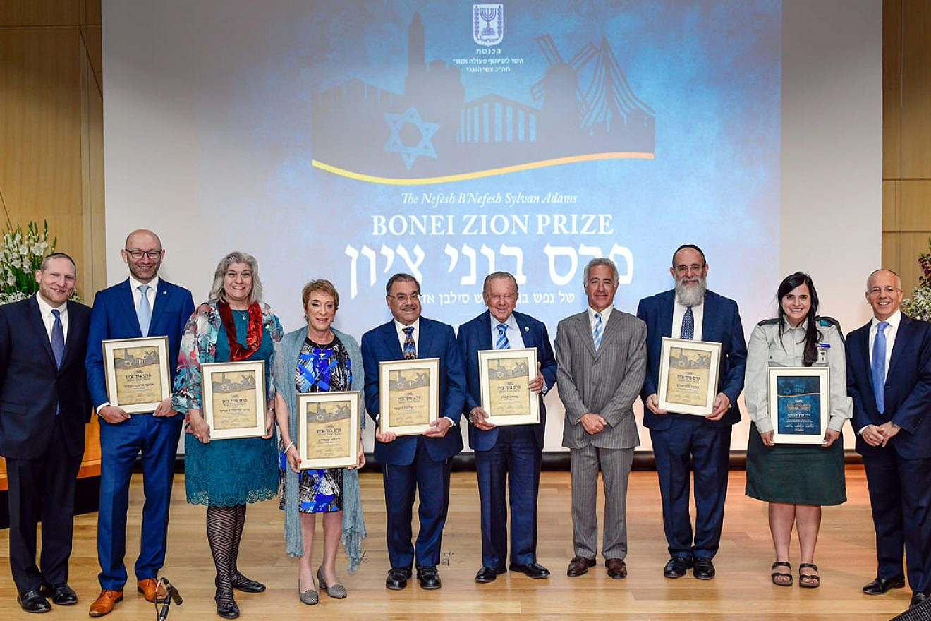 From left: Co-founder and executive director of Nefesh B’Nefesh Rabbi Yehoshua Fass; Arsen Ostrovsky; Dr. Marcia Javitt; Linda Streit; Rabbi Shlomo Riskin; Morris Kahn; Sylvan Adams; Kalman Samuels; IDF Maj. Keren Hajioff; co-founder of Nefesh B'Nefesh; and Tony Gelbart. Photo by Shahar Azran.