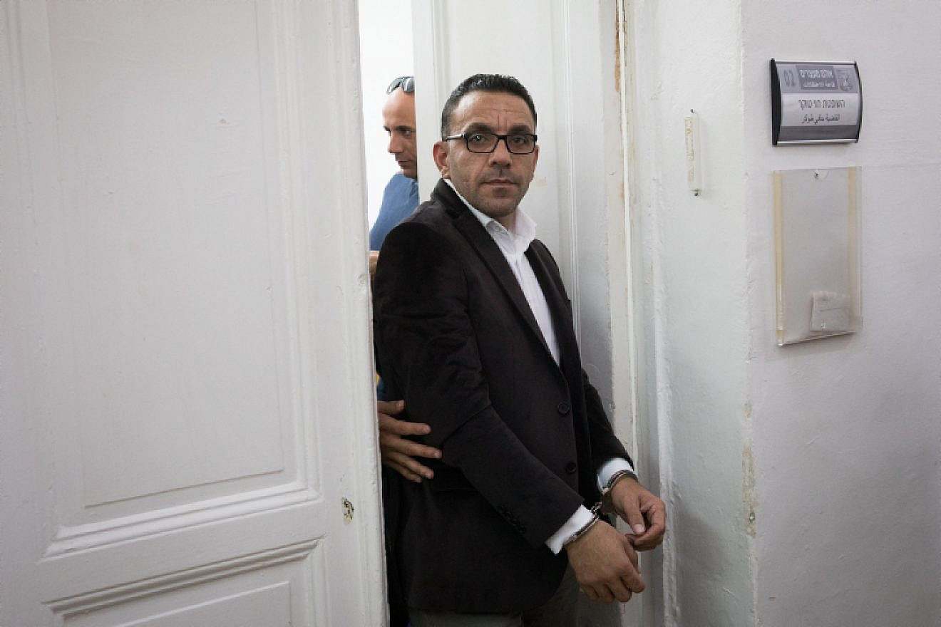 Palestinian Authority Jerusalem “governor” Adnan Ghaith is escorted by police after a court hearing at the Magistrate's Court in Jerusalem on Nov. 25, 2018. Photo by Yonatan Sindel/Flash90.