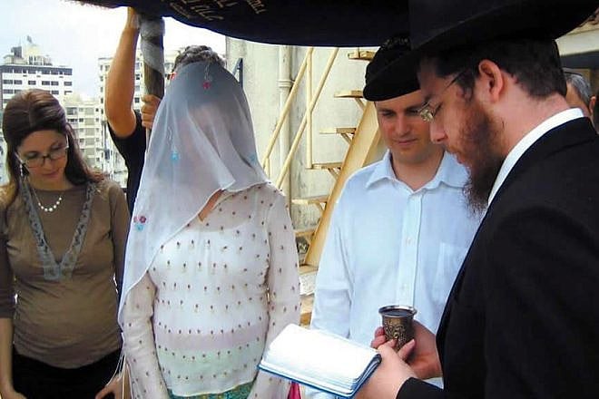 Rabbi Gavriel Holtzberg (right) officiates at a wedding in Mumbai as his wife, Rivka (left) looks on. The Holtzbergs, the founders and directors of Chabad-Lubavitch of Mumbai, were killed along with four guests during a brutal attack on their center 10 years ago. Credit: Chabad.org.