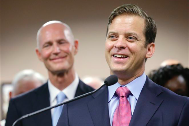 Fla. Lt. Gov. Carlos Lopez-Cantera; to his left is Florida Gov. Rick Scott, soon to be senator. Credit: Screenshot.