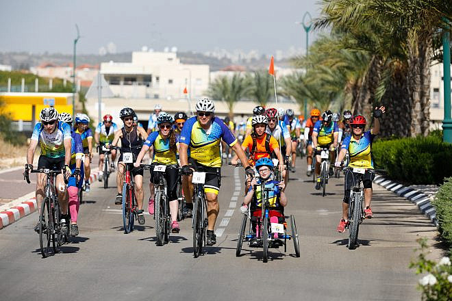 Adults and kids participate in the “Wheels of Love” annual bike race in Israel. Credit: Tomer Feder Sport Photography.