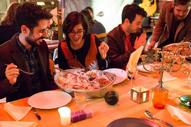 Israelis and Americans enjoy a Thanksgiving dinner together in Tel Aviv on Nov. 29, 2014. Photo by Danielle Shitrit/Flash90.