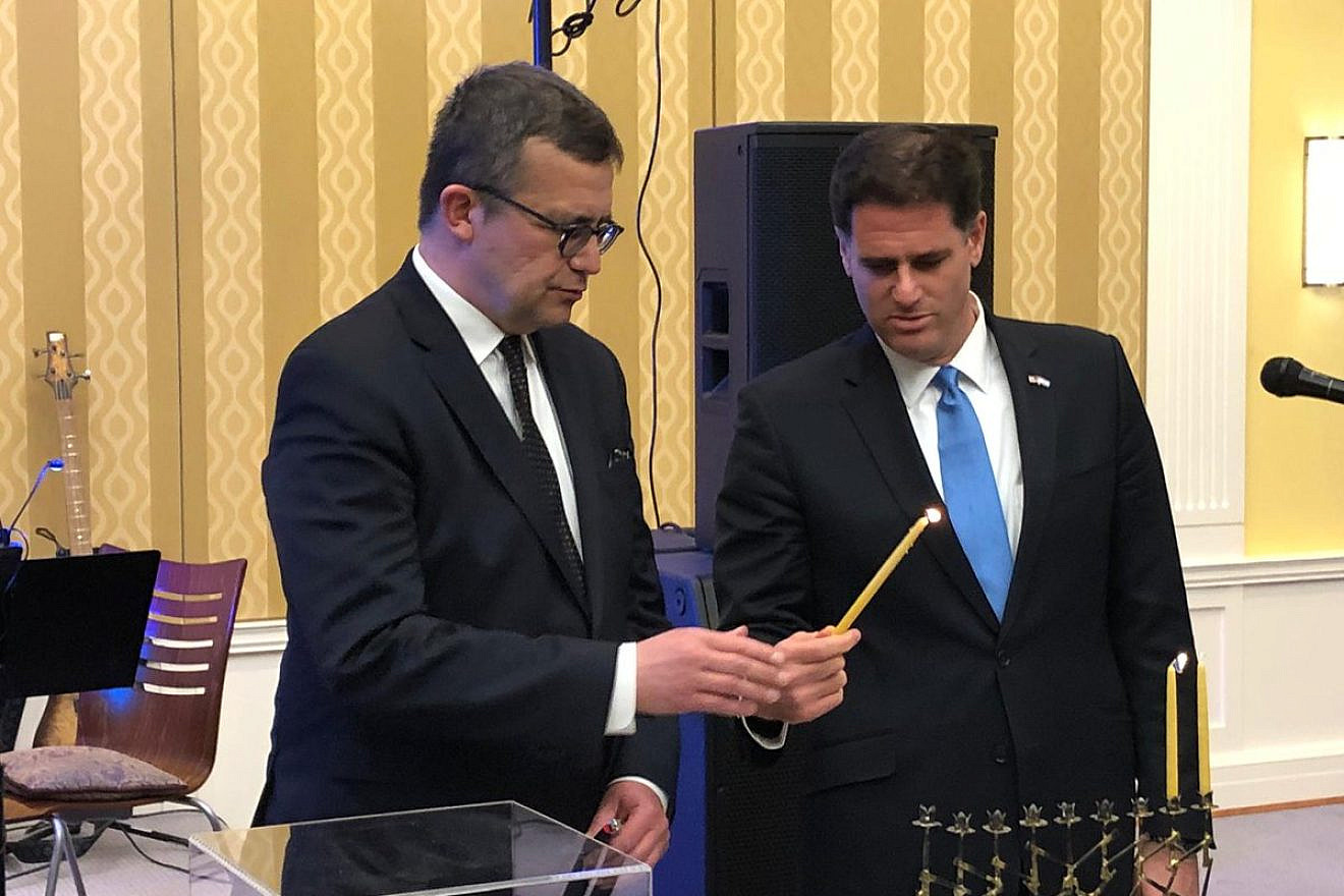 Israeli Ambassador to the United States Ron Dermer lights the menorah  on the second night of Hanukkah with the help of Polish Ambassador to the United States Piotr Wilczek at the Polish embassy in Washington, D.C., on Dec. 3, 2018. Credit: Ambassador Ron Dermer/Twitter.