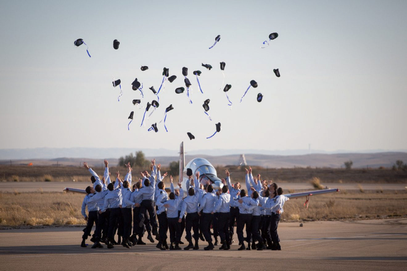 Air Force pilots throw their hats in the air in celebration at a graduation ceremony for soldiers who have completed the official IAF flight course (Hatzerim Air Base, Negev Desert), Dec. 29, 2016. Photo by Miriam Alster/Flash90.