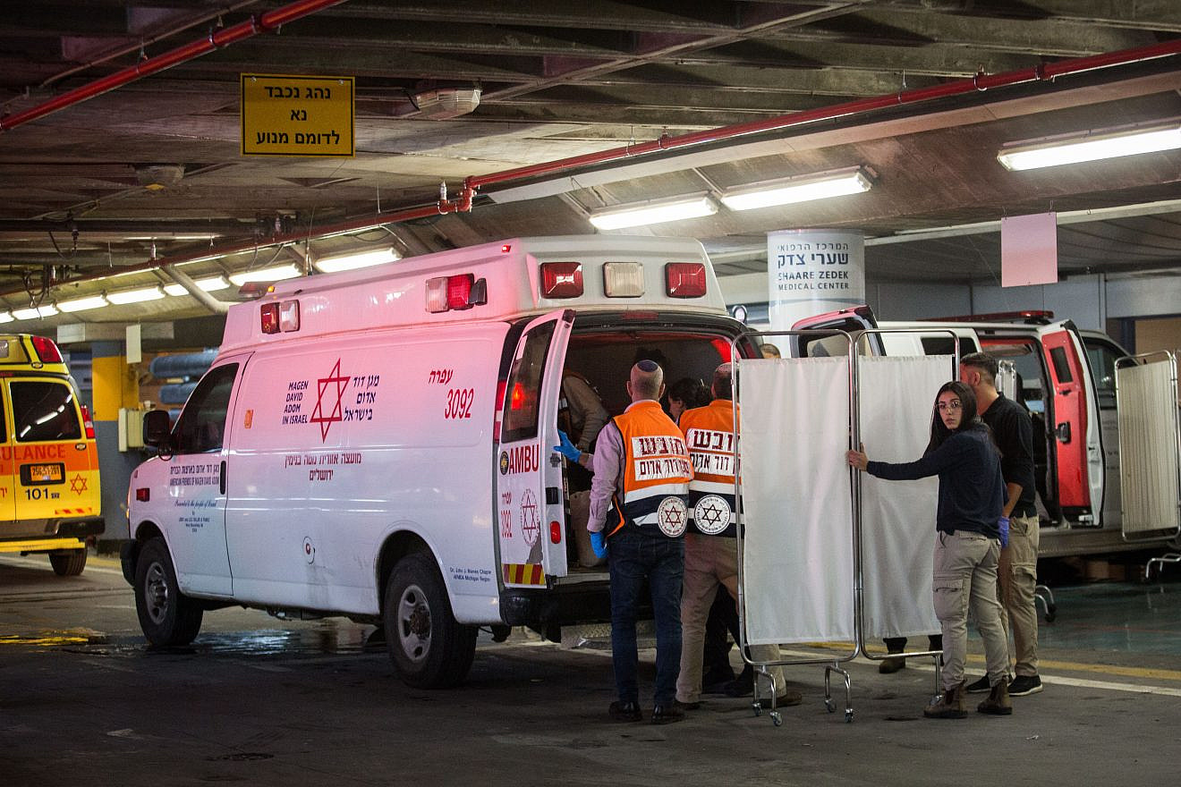 Israeli security and medical personnel evacuate an Israeli woman from the ambulance at the Shaarei Tzedek Medical Center in Jerusalem after she was was seriously injured in a terror attack in Ofra, Dec. 9, 2018. Photo by Hadas Parush/Flash90.