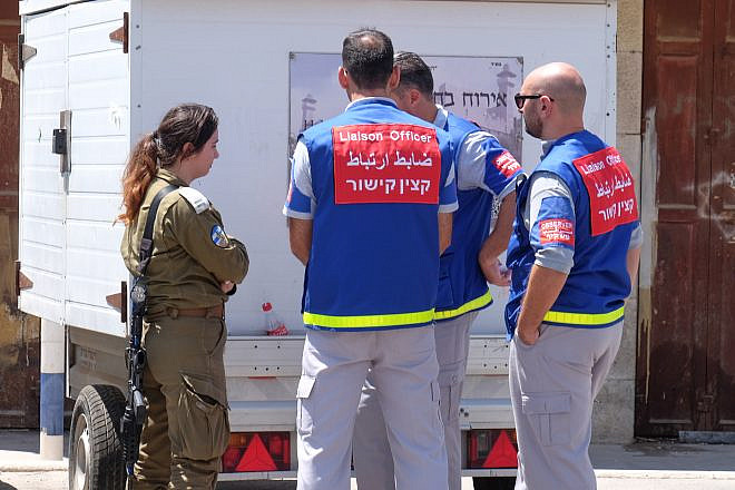 Members of TIPH, or Temporary International Presence speak with Israeli soldier outside the Cave of the Patriarchs in Hebron on August 8, 2018. Photo by Gershon Elinson/Flash90.