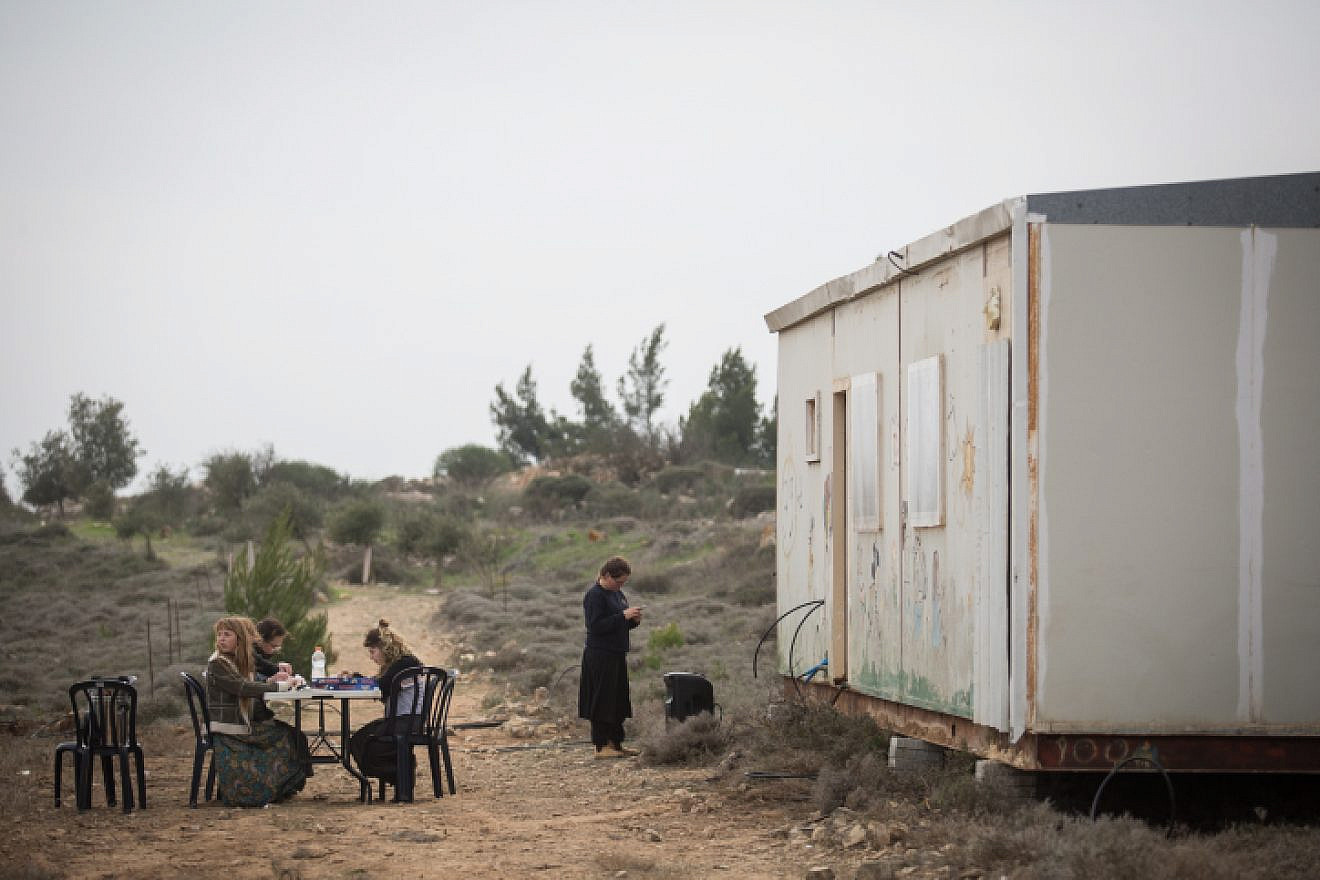 Young Israelis seen at the former outpost of Amona in Samaria, which was evacuated nearly two years ago. Dec. 16, 2018. Photo by Hadas Parush/Flash90.