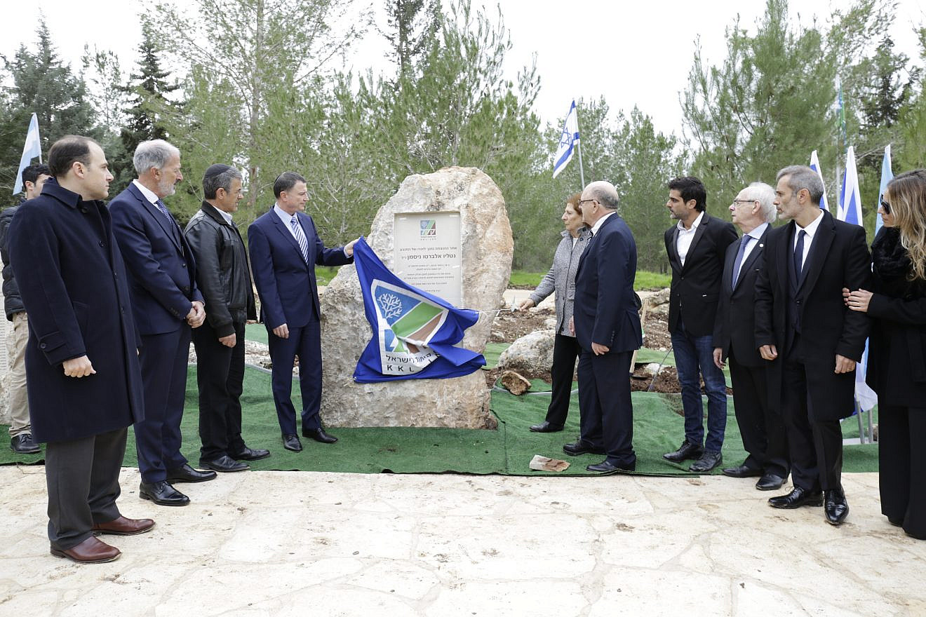 Unveiling a monument honoring former Argentinian prosecutor Alberto Nisman are (from right) former KKL Argentina president Ulises Taitelbaum and his wife, Maria; Miguel Tohimaer; KKL Argentina president Hernáan Hilu; KKL-JNF vice chairman Hernán Felman; Nisman’s mother, Sara Garfunkel; Knesset Speaker Yuli Edelstein; AMIA president Agustin Igdal; DAIA president Jorge Knoblovits; and Argentinian Ambassador to Israel H.E. Mariano Caucino. Credit: KKL-JNF.