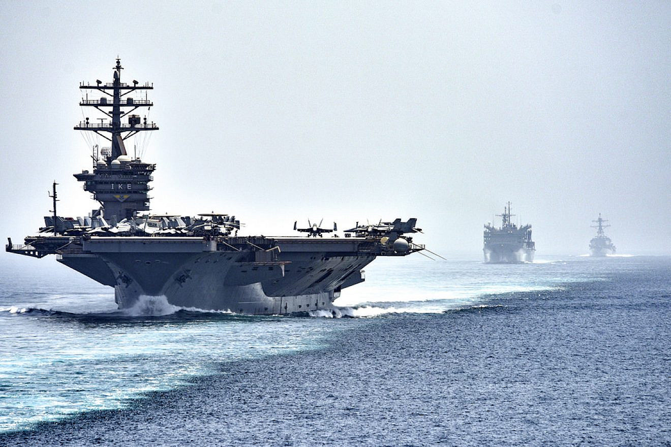 The aircraft carrier “USS Dwight D. Eisenhower," followed by the fast-combat support ship “USNS Arctic” and the guided-missile destroyer “USS Nitze,” transits the Strait of Hormuz. Photo by Mass Communication Specialist 3rd Class J. Alexander Delgado/U.S. Navy.