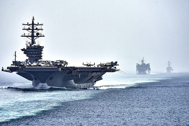The aircraft carrier “USS Dwight D. Eisenhower," followed by the fast-combat support ship “USNS Arctic” and the guided-missile destroyer “USS Nitze,” transits the Strait of Hormuz. Photo by Mass Communication Specialist 3rd Class J. Alexander Delgado/U.S. Navy.
