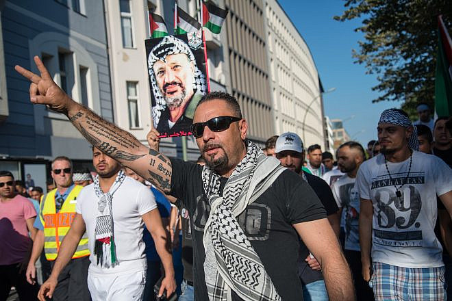 An antisemitic demonstrator in Berlin with Nazi tattoos on arm, July 17, 2014. Photo by Boris Niehaus via Wikimedia Commons.