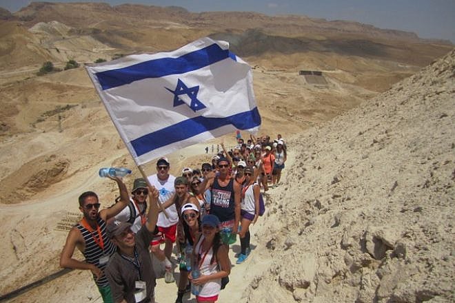 Birthright Israel participants hike up Masada. Credit: Courtesy.