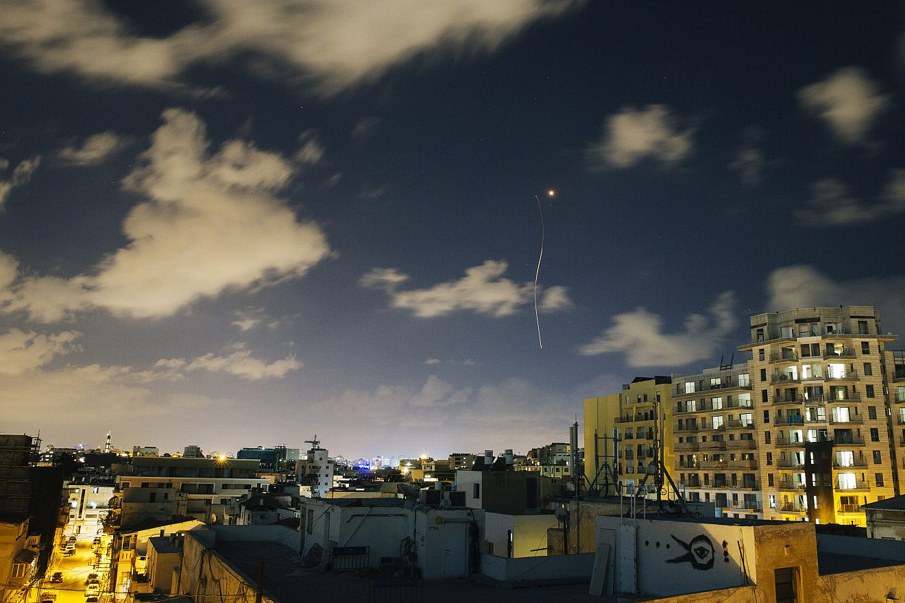 An Iron Dome interceptor rocket flies above the Tel Aviv skyline as seen from a rooftop on July 17, 2014. Credit: Matanya Tausig/Flash90.