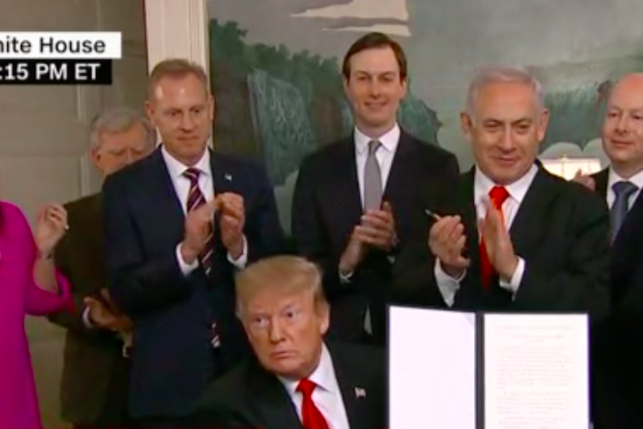 U.S. President Donald Trump holds up a signed declaration of U.S. recognition of Israeli sovereignty over the Golan Heights on March 25, 2019 at the White House. Credit: CNN Screenshot.