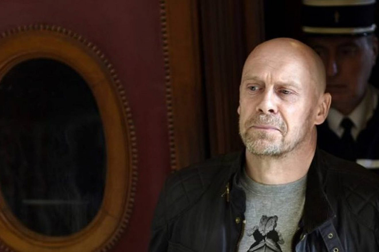 French far-right essayist Alain Soral arrives at the Paris courthouse on March 12, 2015, for his trial for posting a picture on the internet of him taken in Berlin in front of the Memorial to the Murdered Jews of Europe, while gesturing the "quenelle", a gesture viewed as anti-Semitic. The gesture, invented by French controversial comic Dieudonne M'bala M'bala, is viewed as antisemitic. (EJP)
