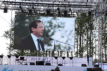 Then-Jewish Agency chairman Isaac Herzog speaks at the annual March of the Living program in Poland on May 2, 2019. Credit: Jewish Agency for Israel.
