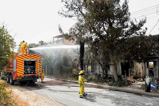 Firefighters extinguish the remains of a fire in in moshav Mevo Modi'im on May 24, 2019. Photo by Avi Dishi/Flash90.