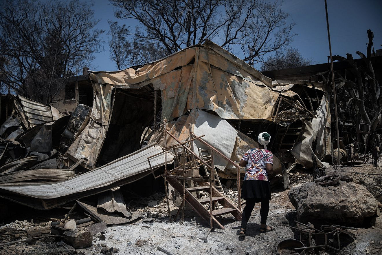 Residents check what is left of their homes after wildfires wiped out most of the houses last week in Mevo Modi’im, near the Ben Shemen Forest, on May 26, 2019. Credit: Hadas Parush/Flash90.
