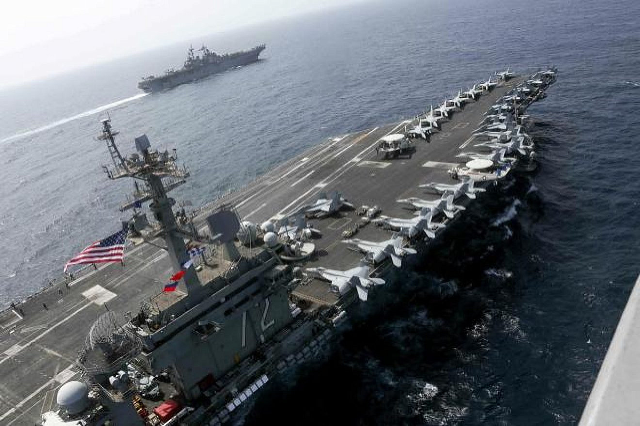 The “USS Abraham Lincoln” aircraft carrier sails in the Arabian Sea near the amphibious assault ship “USS Kearsarge,” equipped with vertical landing and takeoff aircraft and more than 1,600 Marines, May 15, 2019. Credit: U.S. Navy.
