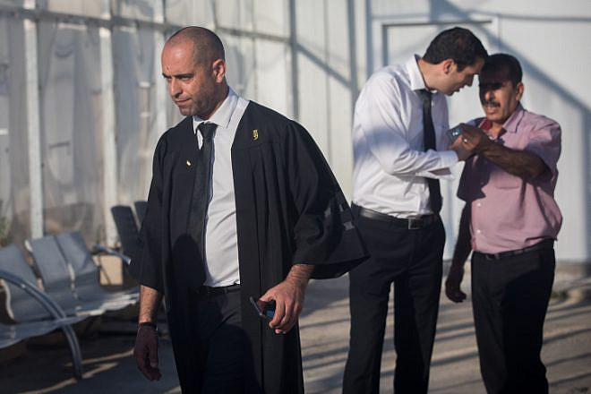 Nashef Darwish (left), the attorney for Mahmoud Katusa, a Palestinian man charged with kidnapping and raping a 7-year-old Israeli girl few months ago, stands outside Israel's Ofer military court on June 19, 2019. Photo by Yonatan Sindel/Flash90.