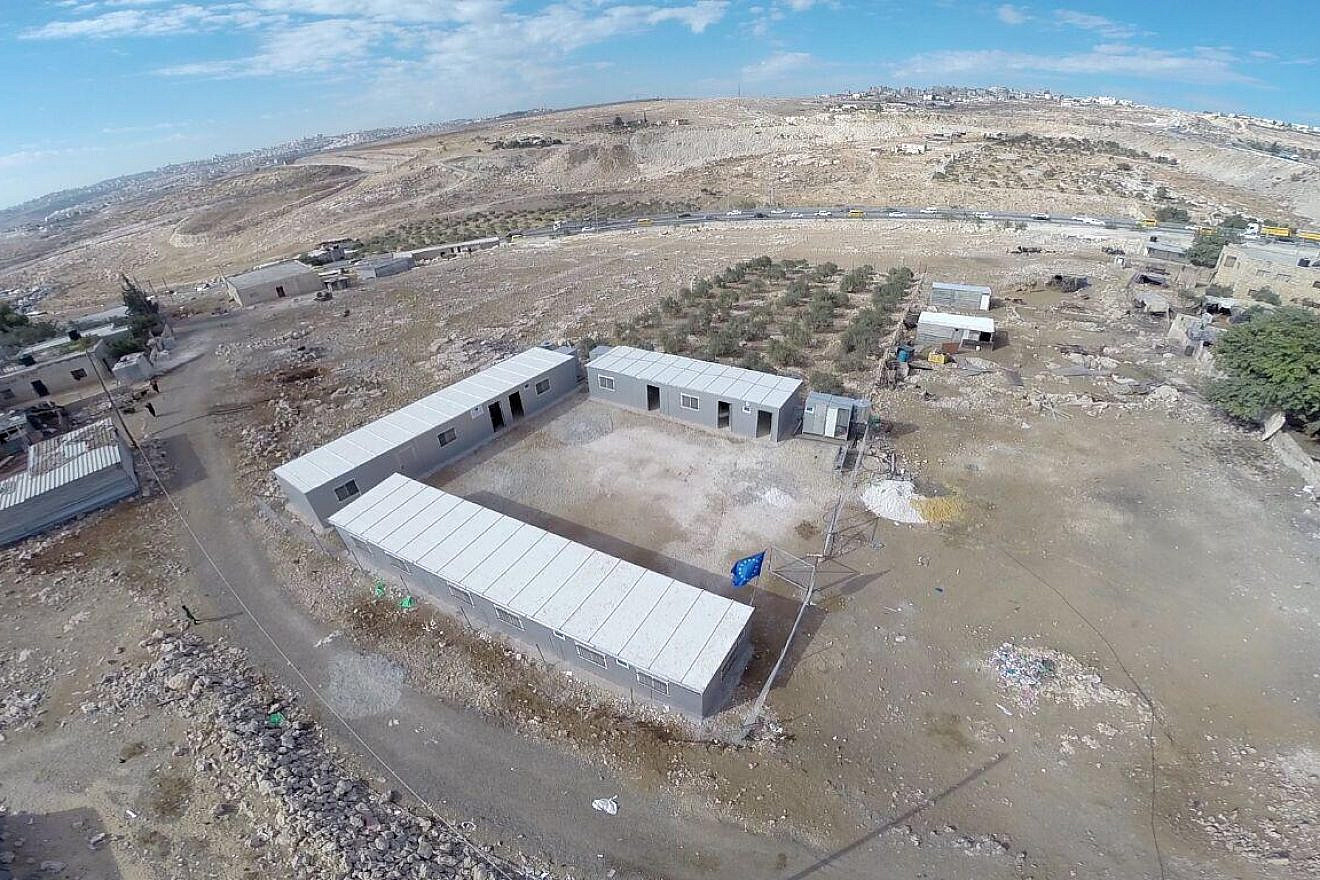 The European Union flag flies over illegal construction in Area C of Judea and Samaria. Credit: Courtesy.