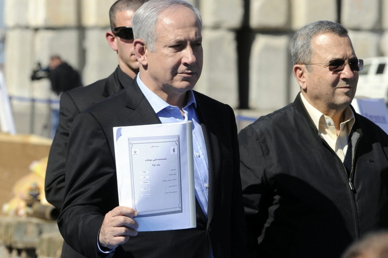 Israeli Prime Minister Benjamin Netanyahu and Defense Minister Ehud Barak hold an Iranian instruction manual for the C-704 anti-ship missile written in Persian, which further highlights Iran's involvement in the weapons smuggling onboard the "Victoria." The manual contained various emblems of the Iranian government, March 16, 2011. Credit: IDF.