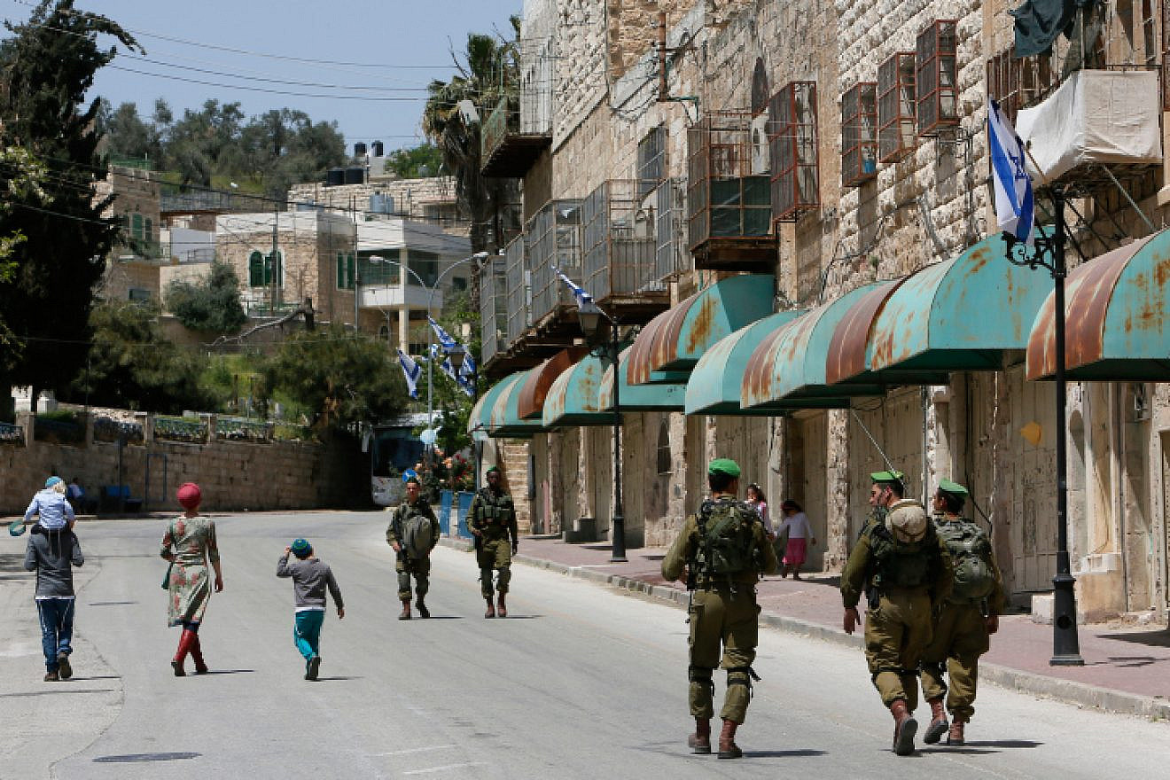 Israeli soldiers seen patrolling on Shuhada Street in Hebron, April 16, 2014. Photo by Miriam Alster/Flash90.