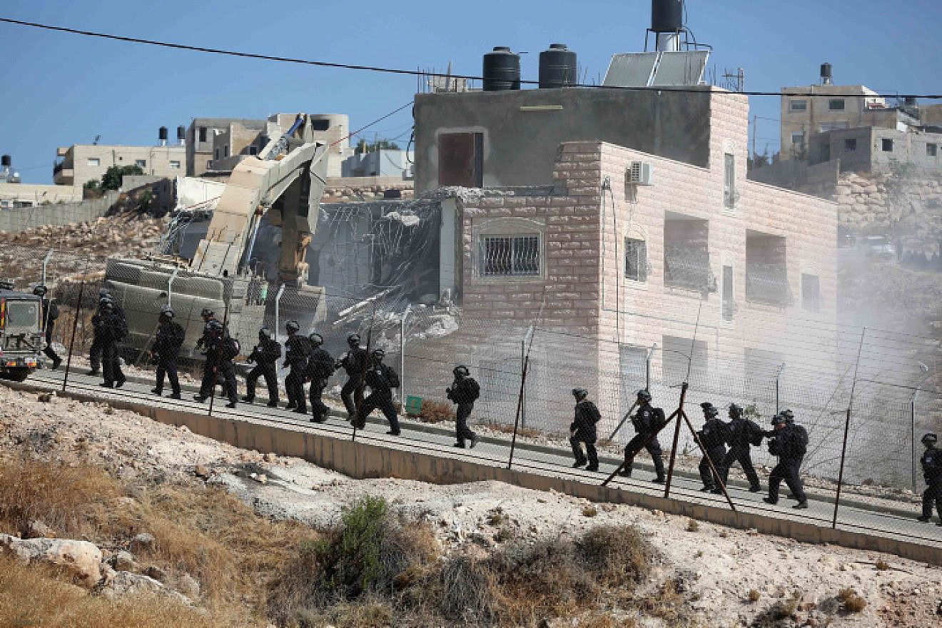 An Israeli military bulldozer demolishes a building in Sur Baher on July 22, 2019. Photo by Wisam Hashlamoun/Flash90.