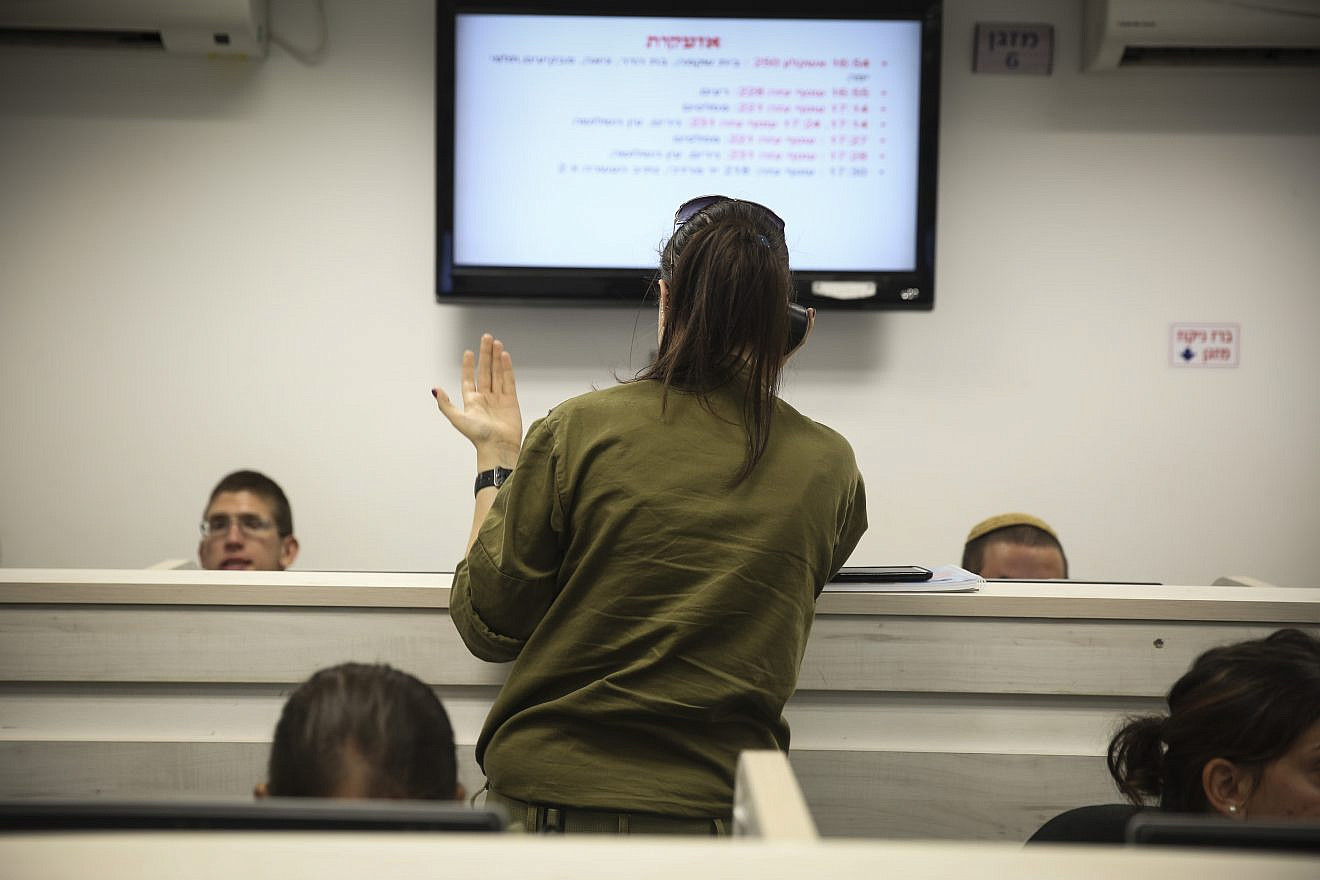 Israeli soldiers work at the call center of the Home Front Command, in the central Israeli city of Ramle. Photo by Hadas Parush/Flash90.