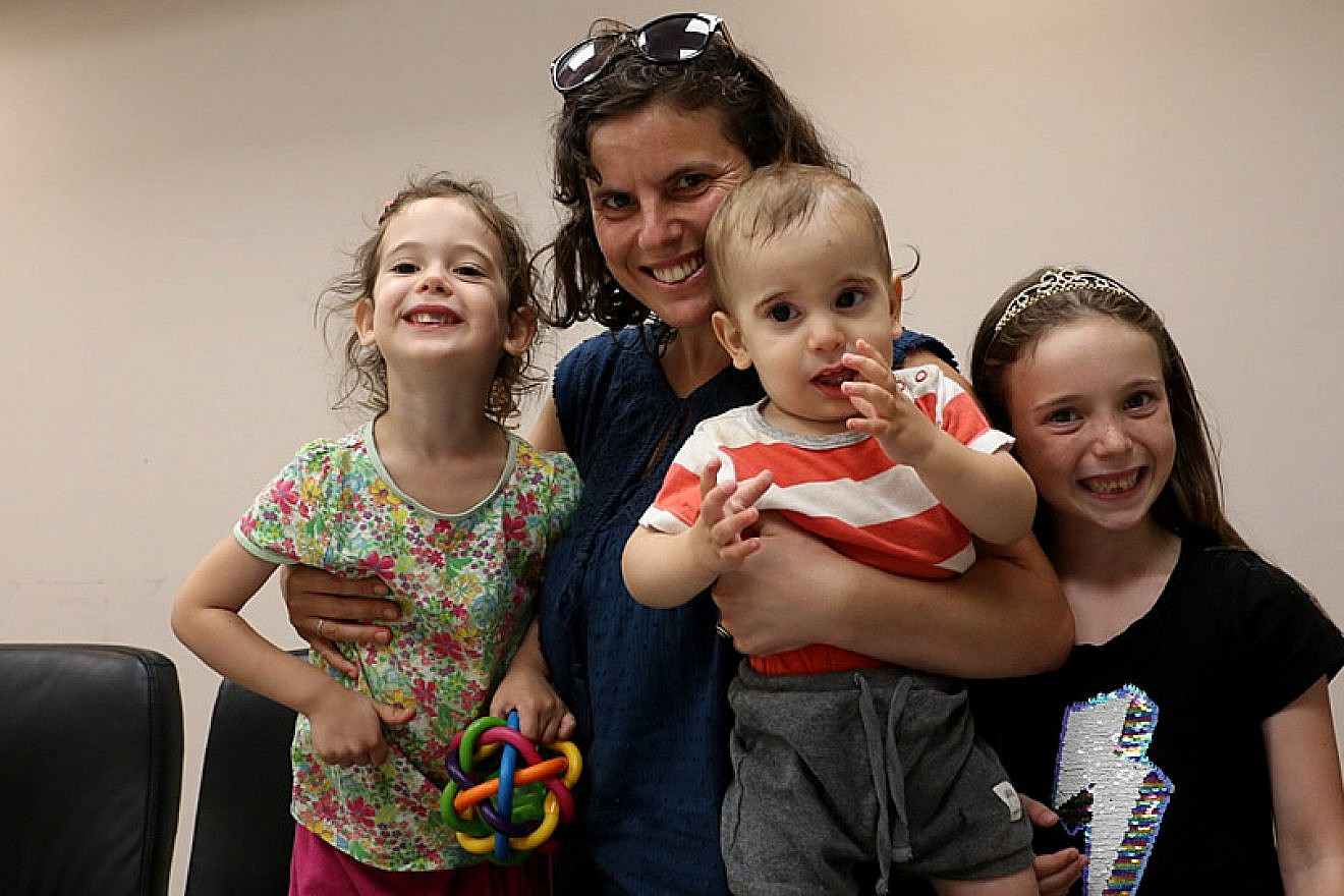 An Israeli family who lost their home in a fire that consumed moshav Mevo Modi’im in May gets some welcome financial assistance to help rebuild their lives, July 2019. Credit: IFCJ.