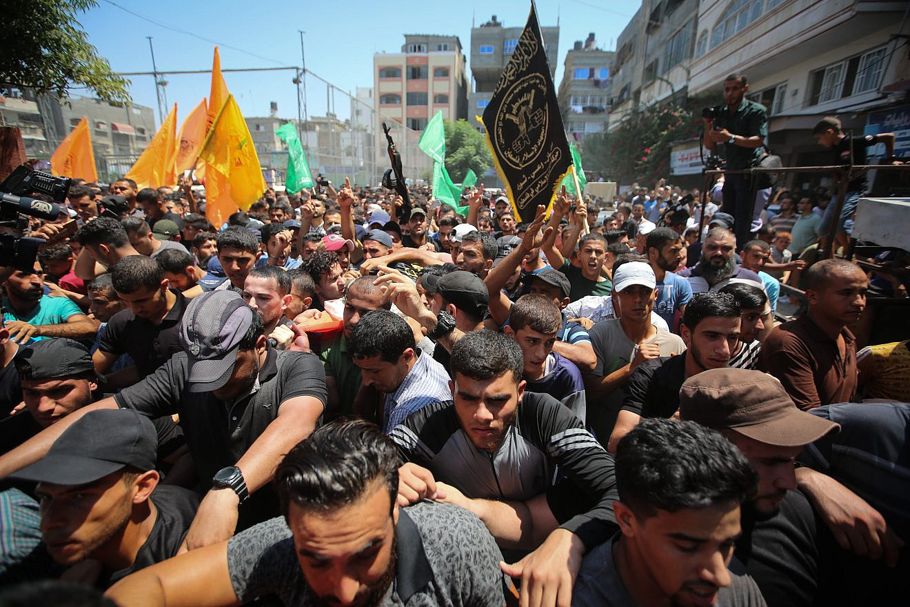 Mourners carry the body of Palestinian gunman Mohamad Al-Tramsi during his funeral in the Gaza Strip on Aug. 18, 2019. Al-Tramsi was killed along with two other Palestinians by IDF shelling in response to an infiltration attempt into Israel. Credit: Hassan Jedi/Flash90.