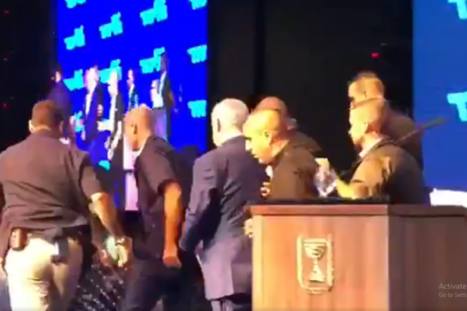 Israeli Prime Minister Benjamin Netanyahu is rushed off stage by bodyguards during a campaign event in Ashdod, Sept. 10, 2019. Source: Screenshot.