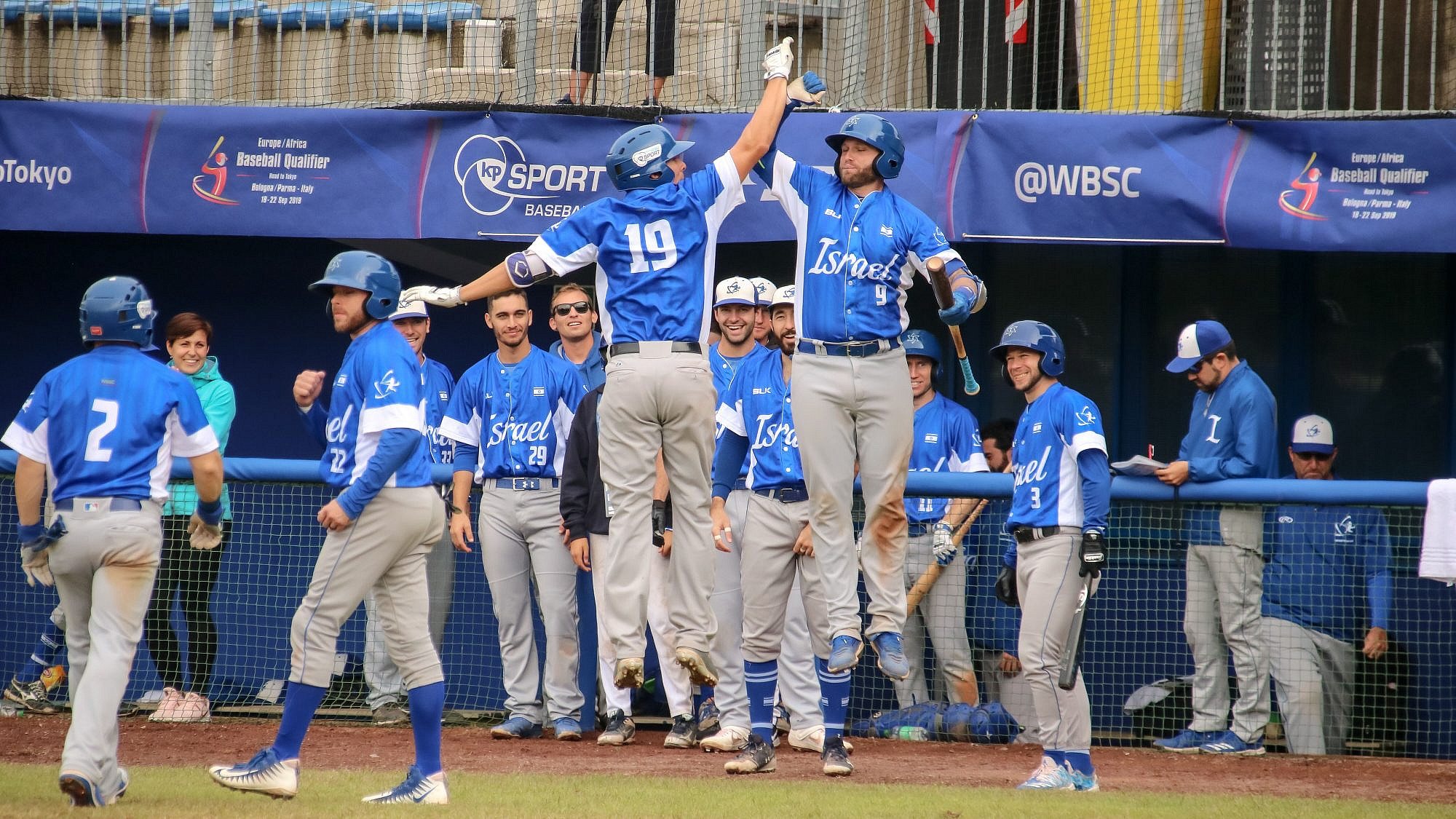 Danny Valencia, No. 19 (left, in the air) and Nick Rickles after Team Israel's win in Game 5 against South Africa. Photo by Margo Sugarman.