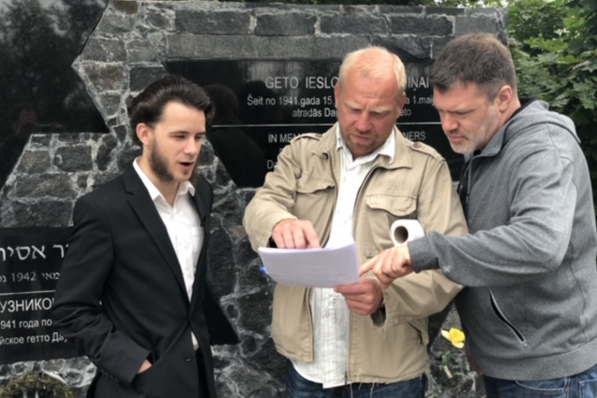 From left: Host Levs Perlovs, writer Andrejs Hramcovs and producer Eugene Levin filming at the Daugavpills Ghetto Memorial in Latvia. Photo by Jeff Hoffman.