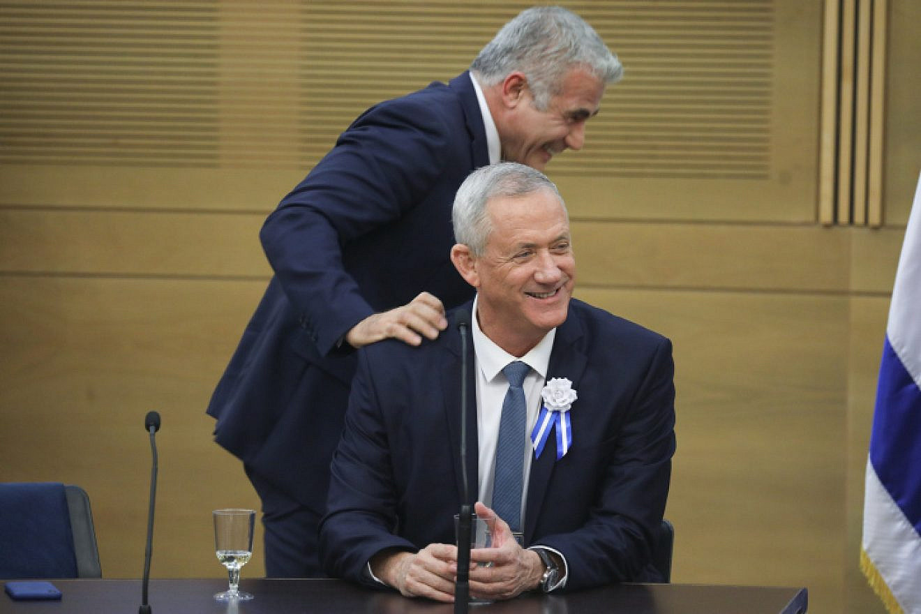 Blue and White Party leaders Benny Gantz (seated) and Yair Lapid at a faction meeting at the opening of the 22nd Knesset in Jerusalem, on Oct. 3, 2019. Photo by Hadas Parush/Flash90.