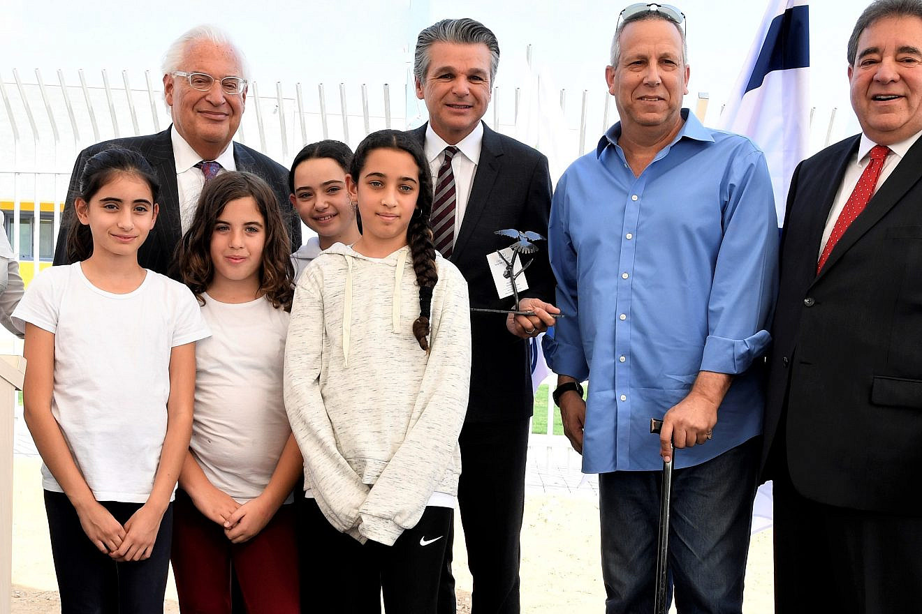 From left: Michal Uziyahu, Eshkol Region director of community centers, U.S. Ambassador to Israel David Friedman, Pastor Jentezen Franklin, Eshkol Mayor Gadi Yarkoni and JNF-USA CEO Russell Robinson join children in dedicating a new Playschool to relieve some of the stress and trauma experienced by living so close to voilence coming from the Gaza Strip, Nov. 6, 2019. Credit: JNF.