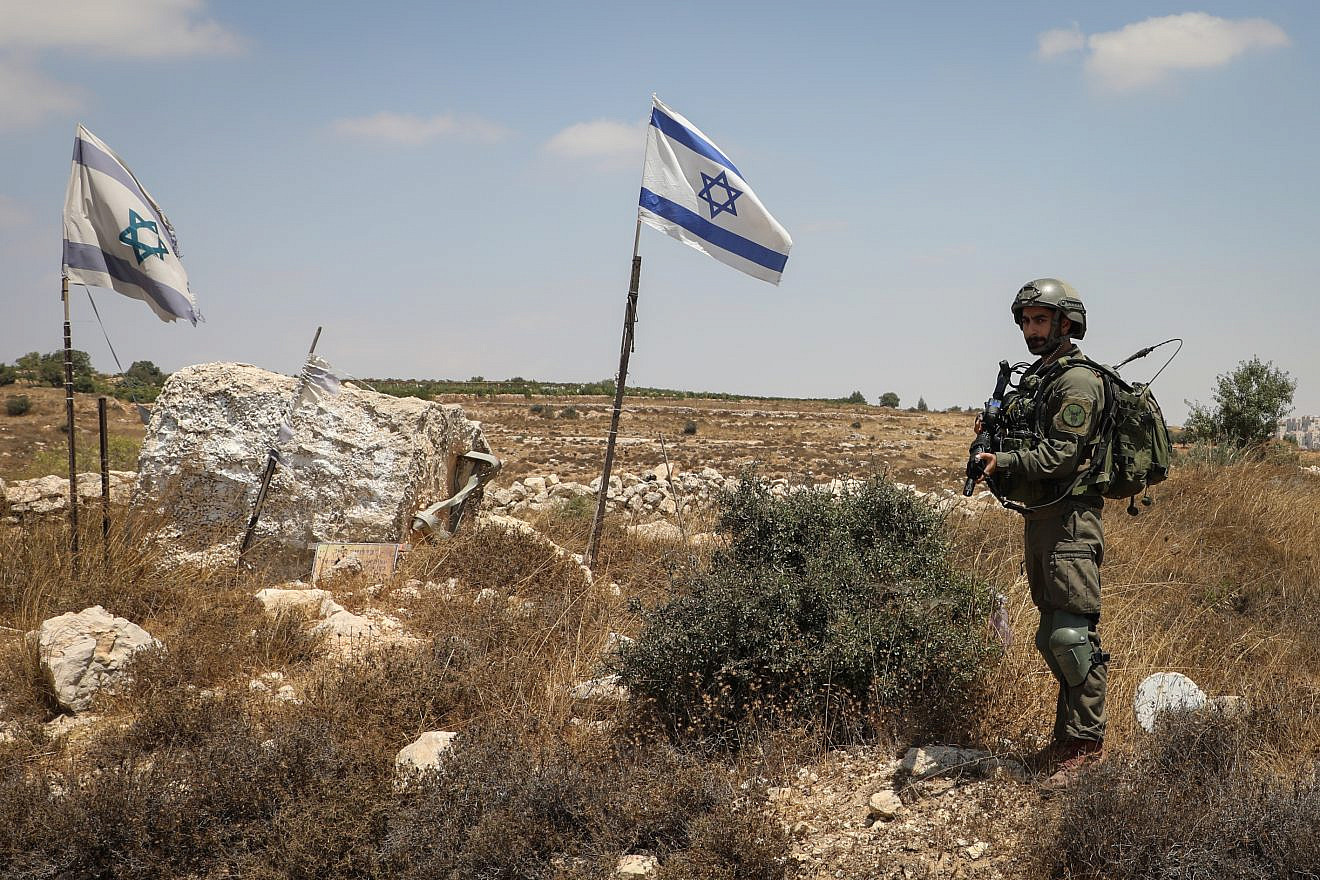 An Israeli soldier stands guard at the site of a car-ramming attack in Elazar, Gush Etzion, Aug. 18, 2019. Photo by Gershon Elinson/Flash90.