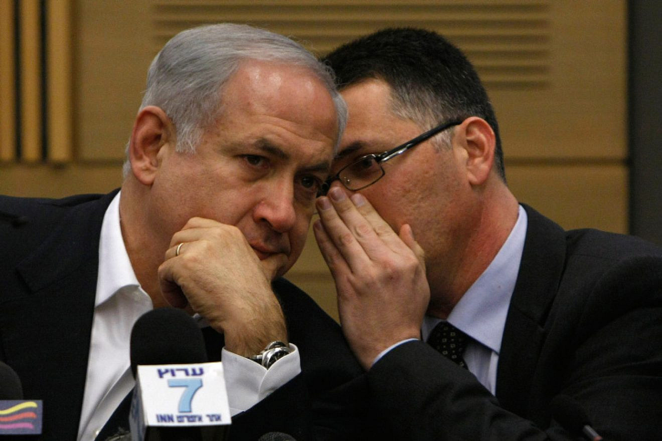 Likud Party leader Benjamin Netanyahu speaks with Knesset member Gideon Sa’ar at the party meeting in the Knesset in Jerusalem on March 2, 2009. Photo by Miriam Alster/Flash90.