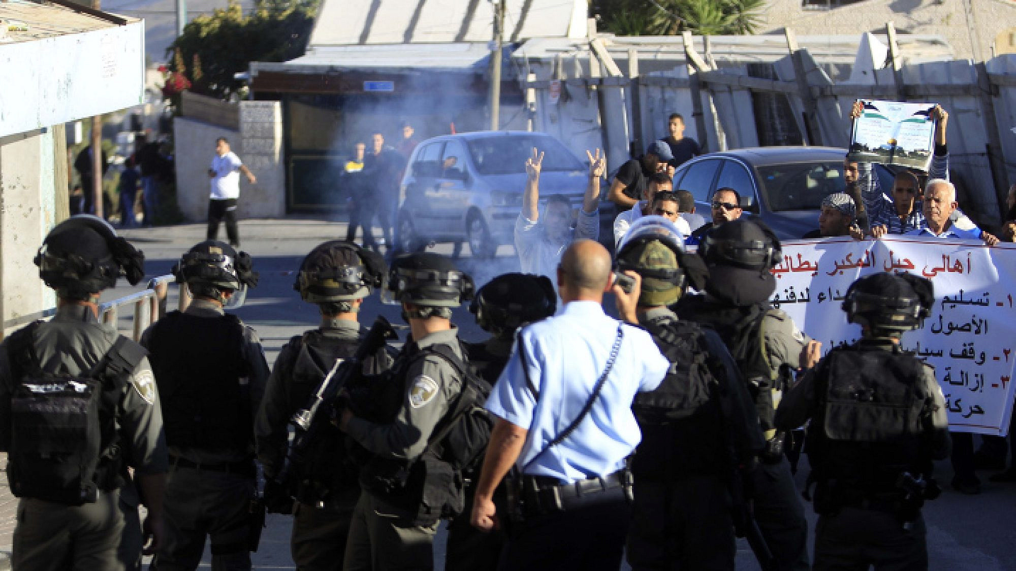 Palestinian men shout during clashes with Israeli security forces at a protest in the eastern Jerusalem neighborhood of Jabel Mukaber, demanding they be given the bodies of the Palestinian men killed in terror attacks. Nov. 13, 2015. Photo by Muammar Awad/Flash90.