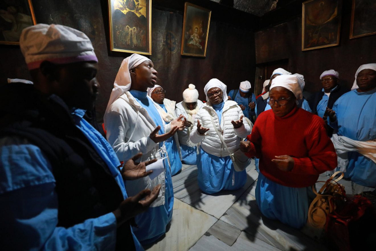 Christian pilgrims pray inside the Church of the Nativity in the West Bank city of Bethlehem, on Dec. 24, 2019. Photo by Flash90.