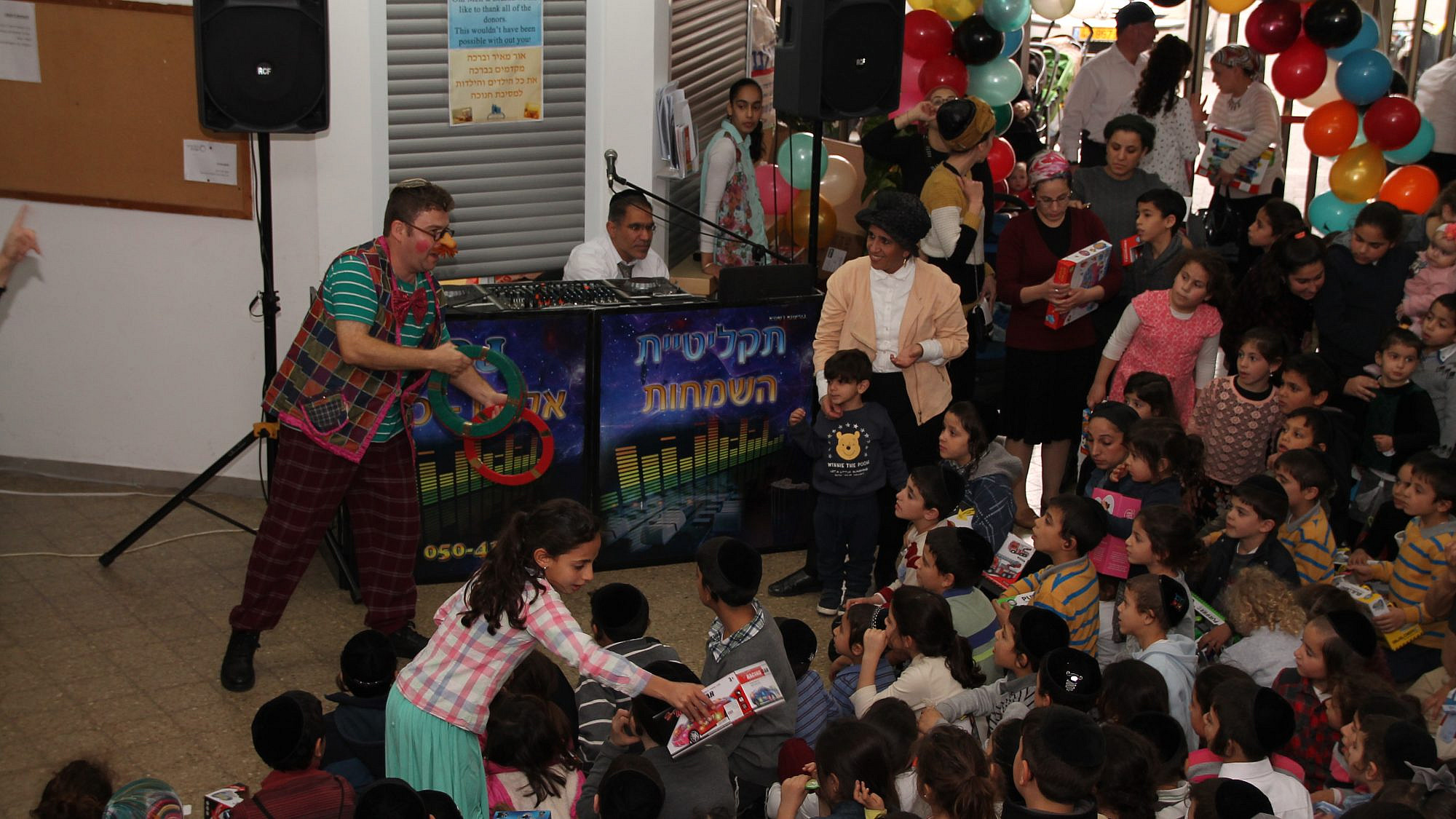 Ohr Meir & Bracha: The Terror Victims Support Center hosts an annual Hanukkah party for hundreds, complete with a clown and toy giveaways, December 2019. Credit: Courtesy.