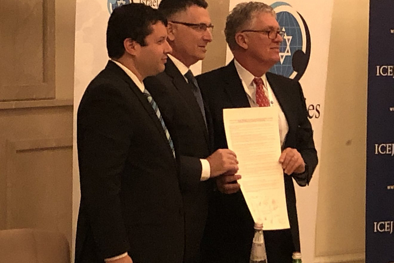 Israel Allies Foundation President Josh Reinstein (left), Knesset member Gideon Sa’ar (center) and IAF chairman of the board Dr. Dave Weston hold a pro-Israel resolution signed by parliamentarians worldwide at their annual conference in Jerusalem, Dec. 10, 2019. Photo by Josh Hasten.