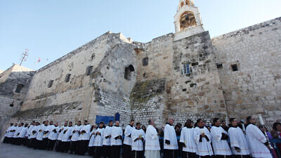 Clergymen gather in the Manger Square outside the Church of  Nativity in the city of Bethlehem on Dec. 24, 2012. Photo by Issam Rimawi / Flash90.