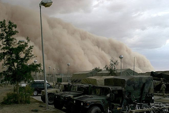 A massive dust storm cloud is close to enveloping a military camp as it rolls over Al Asad, Iraq, just before nightfall on April 27, 2005. Credit: Corporal Alicia M. Garcia/U.S. Marine Corps.