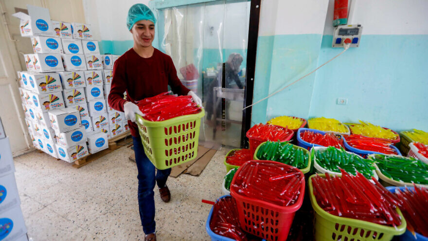 Palestinian workers sort ice pops at a factory in the West Bank village of Tafouh, near Hebron, on April 16, 2019. Photo by Wisam Hashlamoun/Flash90.