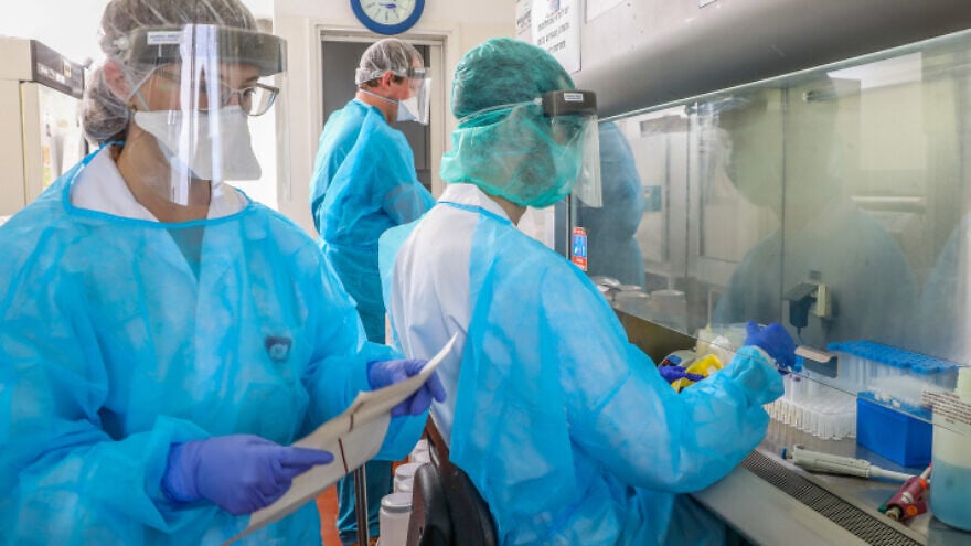 Technicians carry out a diagnostic test for COVID-19 in a lab at the Rambam Health Care Campus in Haifa, on March 30, 2020. Photo by Yossi Aloni/Flash90.