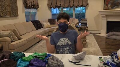 A member of the Jason family from Houston shows off his new protective gear, April 2020. Source: Screenshot.