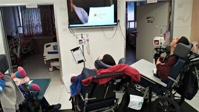 ALEH residents with severe disabilities enjoy their favorite quarantine activity: watching the story time videos created just for them by Californian children's book author Jamie Kiffel-Alcheh. Credit: Courtesy.